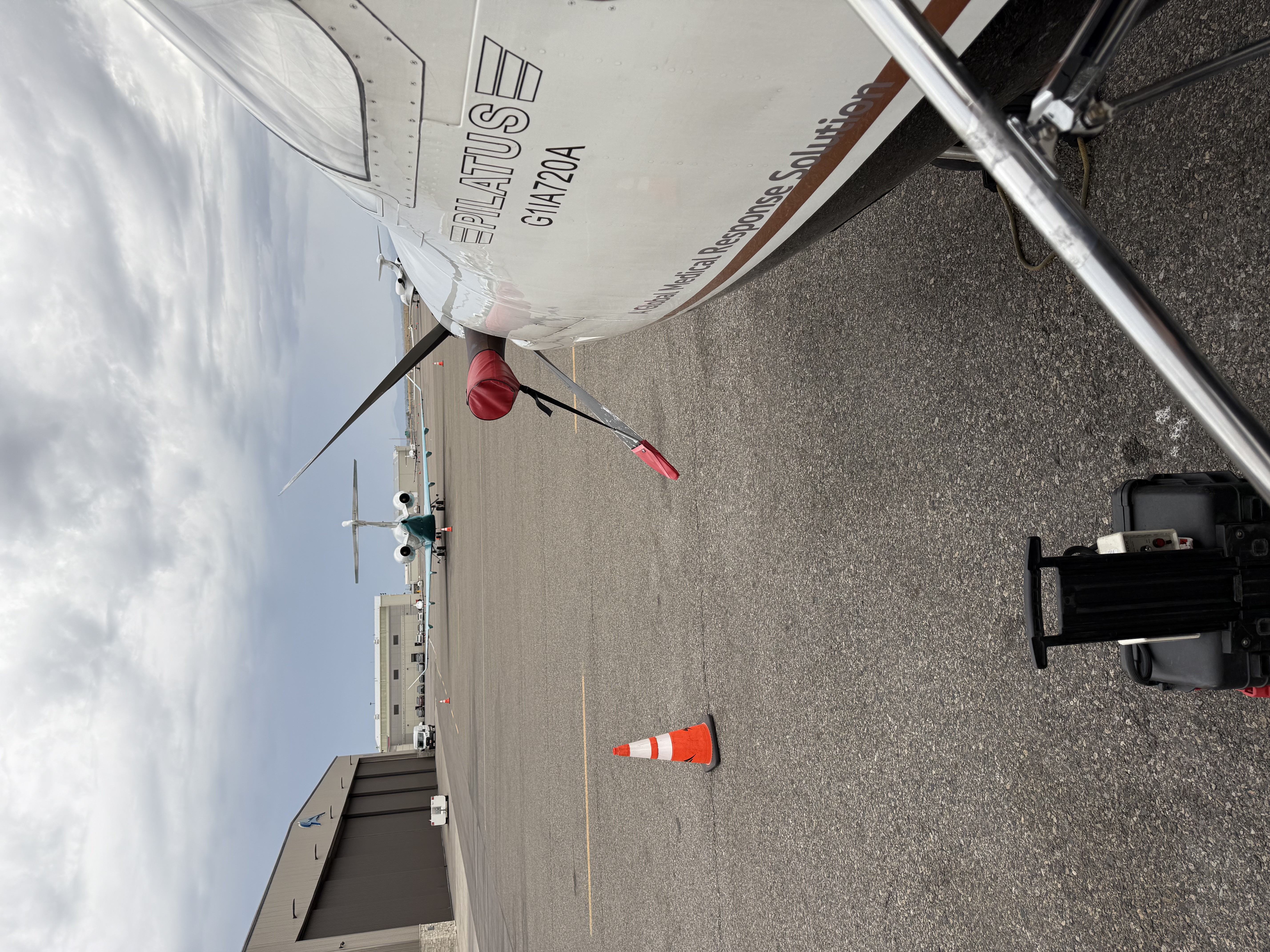 Pilatus aircraft parked on the ramp beside the hangars